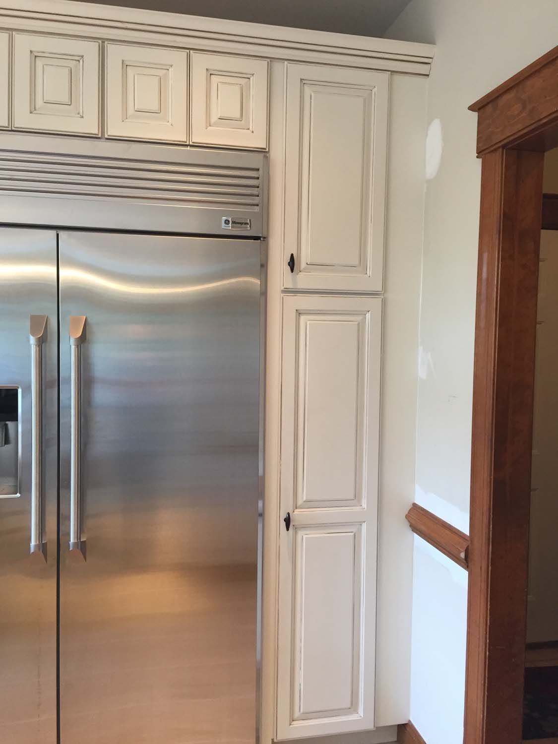 A kitchen with stainless steel appliances and white cabinets