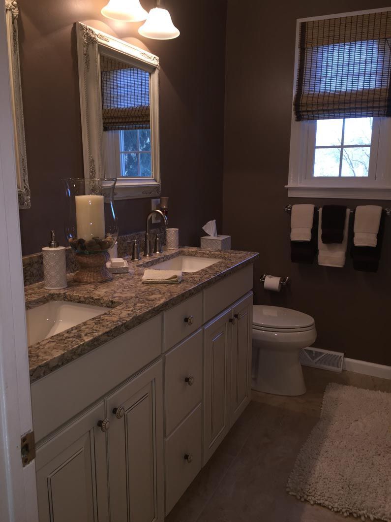 A bathroom with two sinks and a toilet