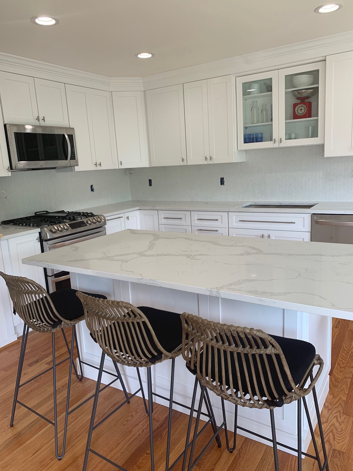 A kitchen with a large island and stools