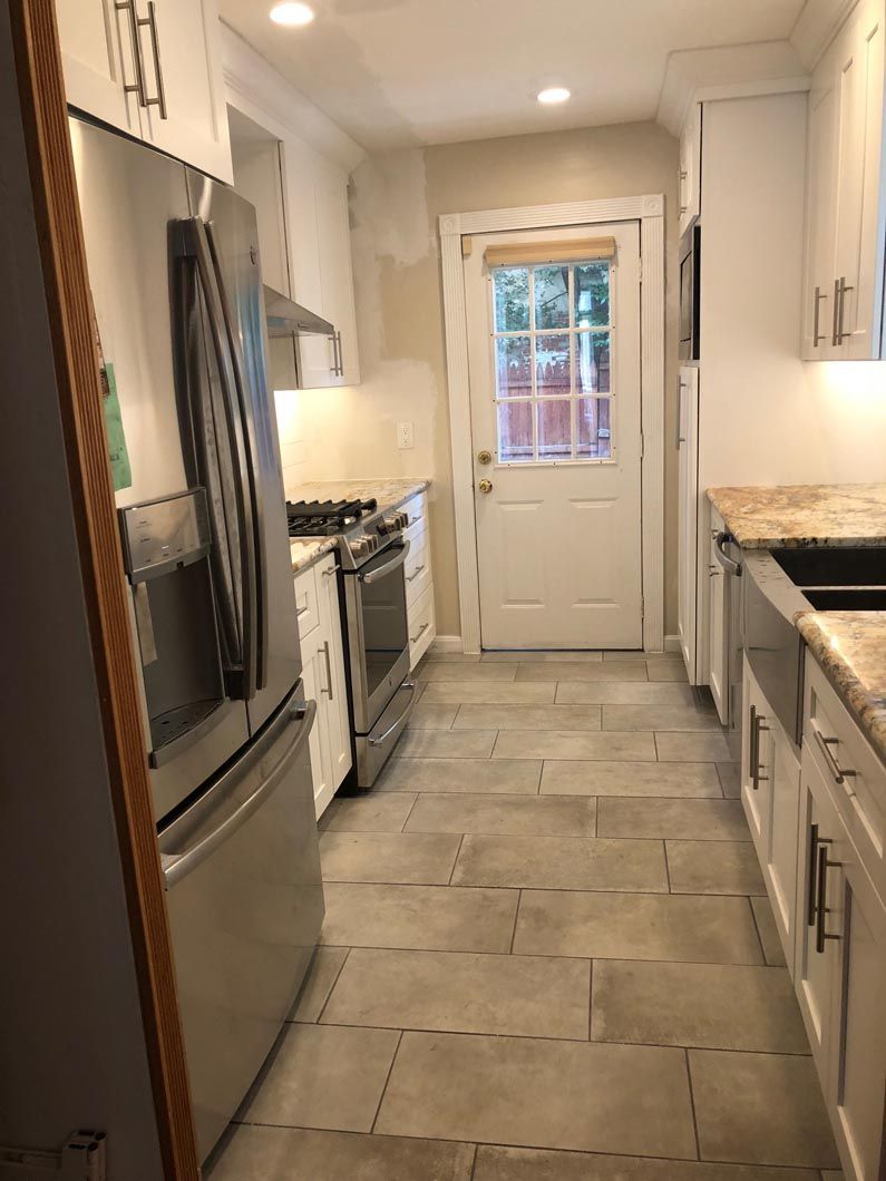 A kitchen with stainless steel appliances and granite counter tops.