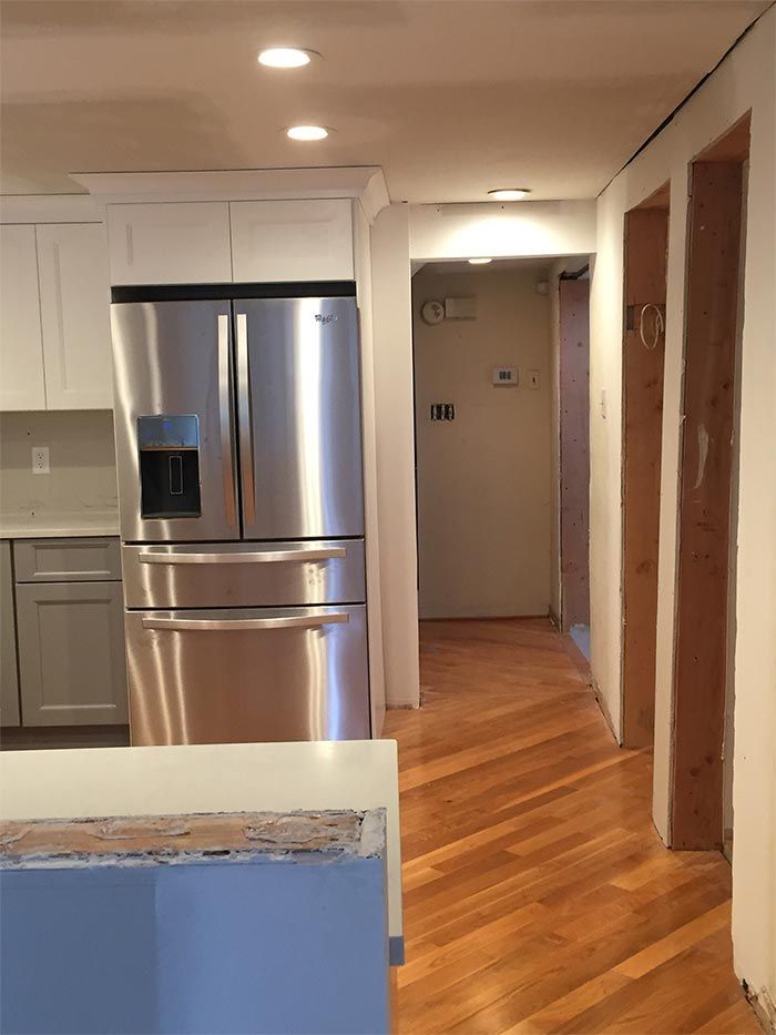 A kitchen with stainless steel appliances and white cabinets