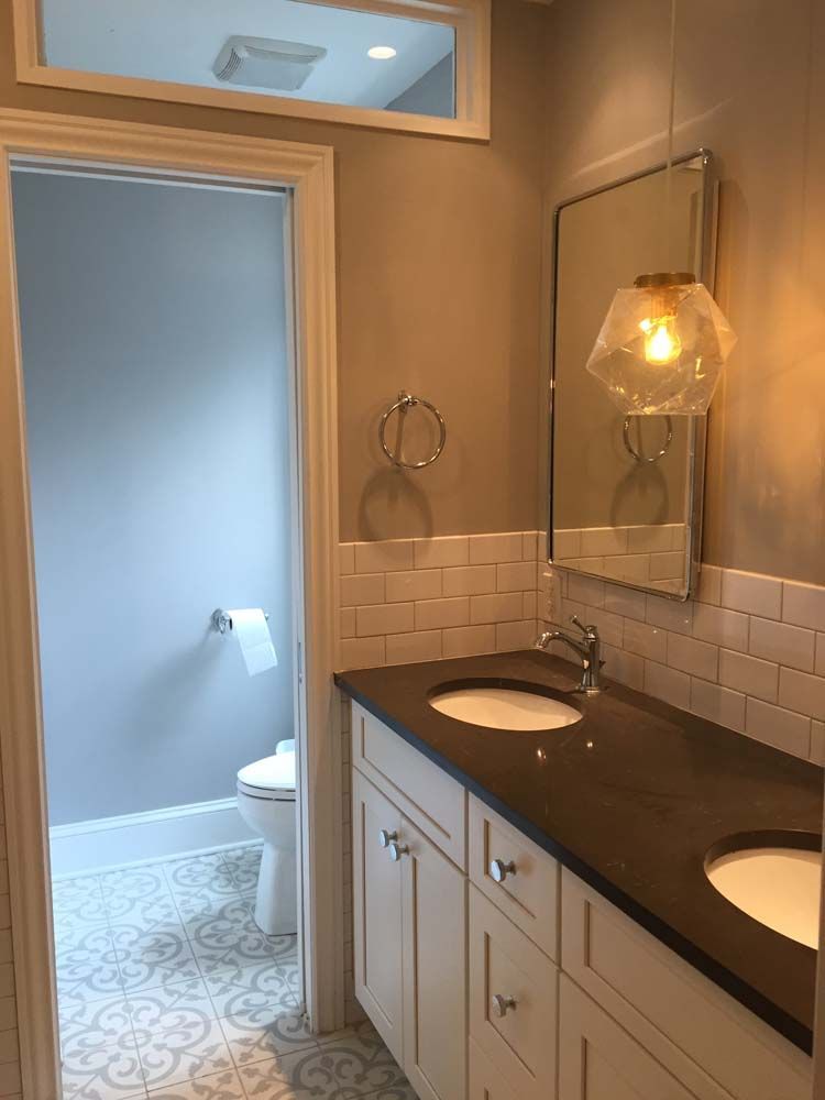 A bathroom with two sinks and a mirror