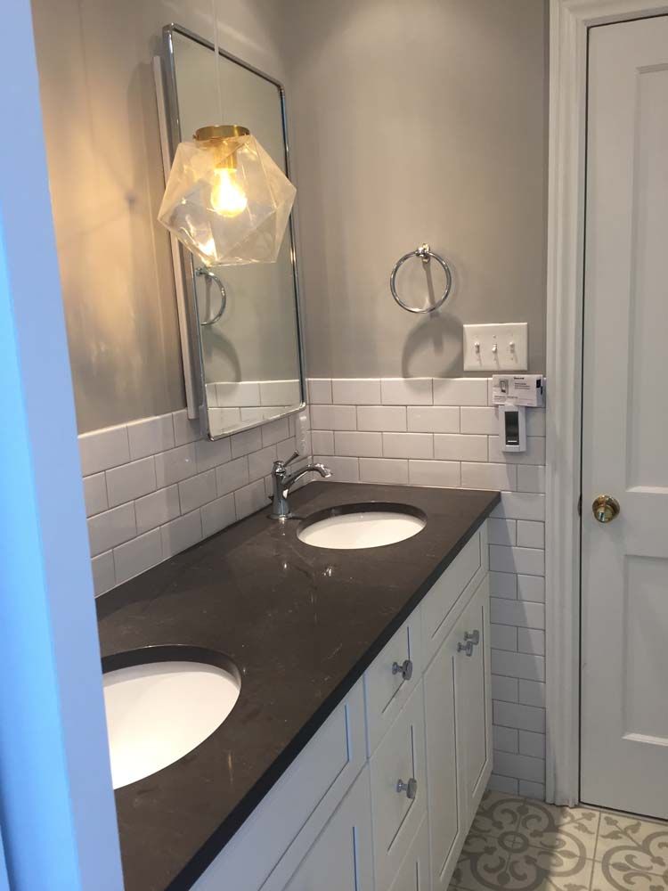 A bathroom with two sinks and a mirror.