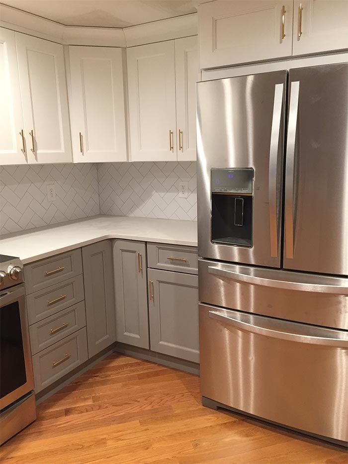 A kitchen with stainless steel appliances and white cabinets