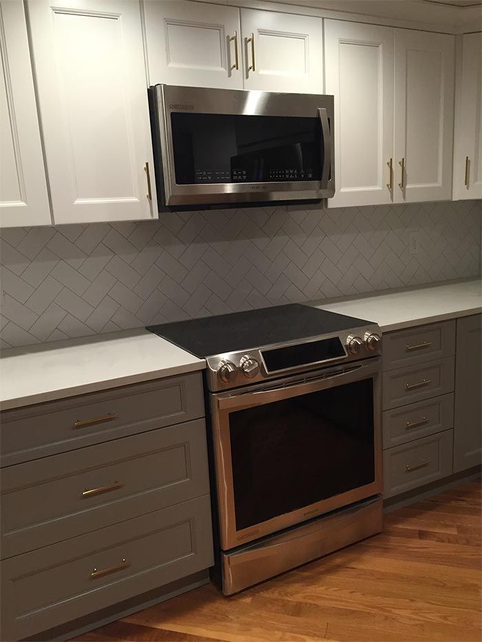 A kitchen with stainless steel appliances and white cabinets