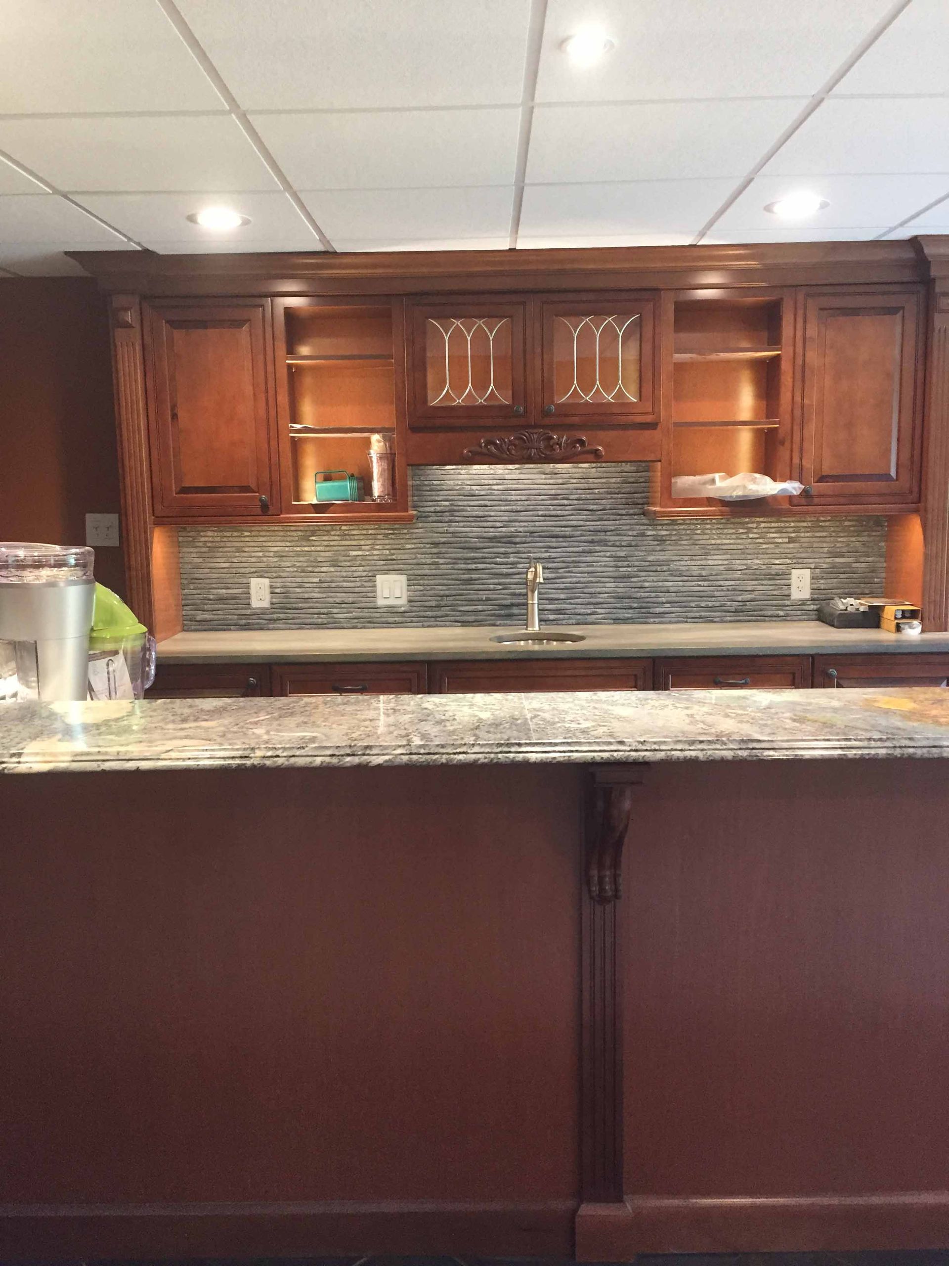 A kitchen with wooden cabinets and a granite counter top