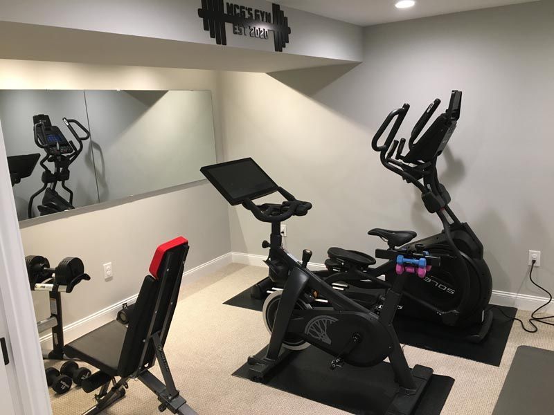 A gym with exercise bikes and a large mirror