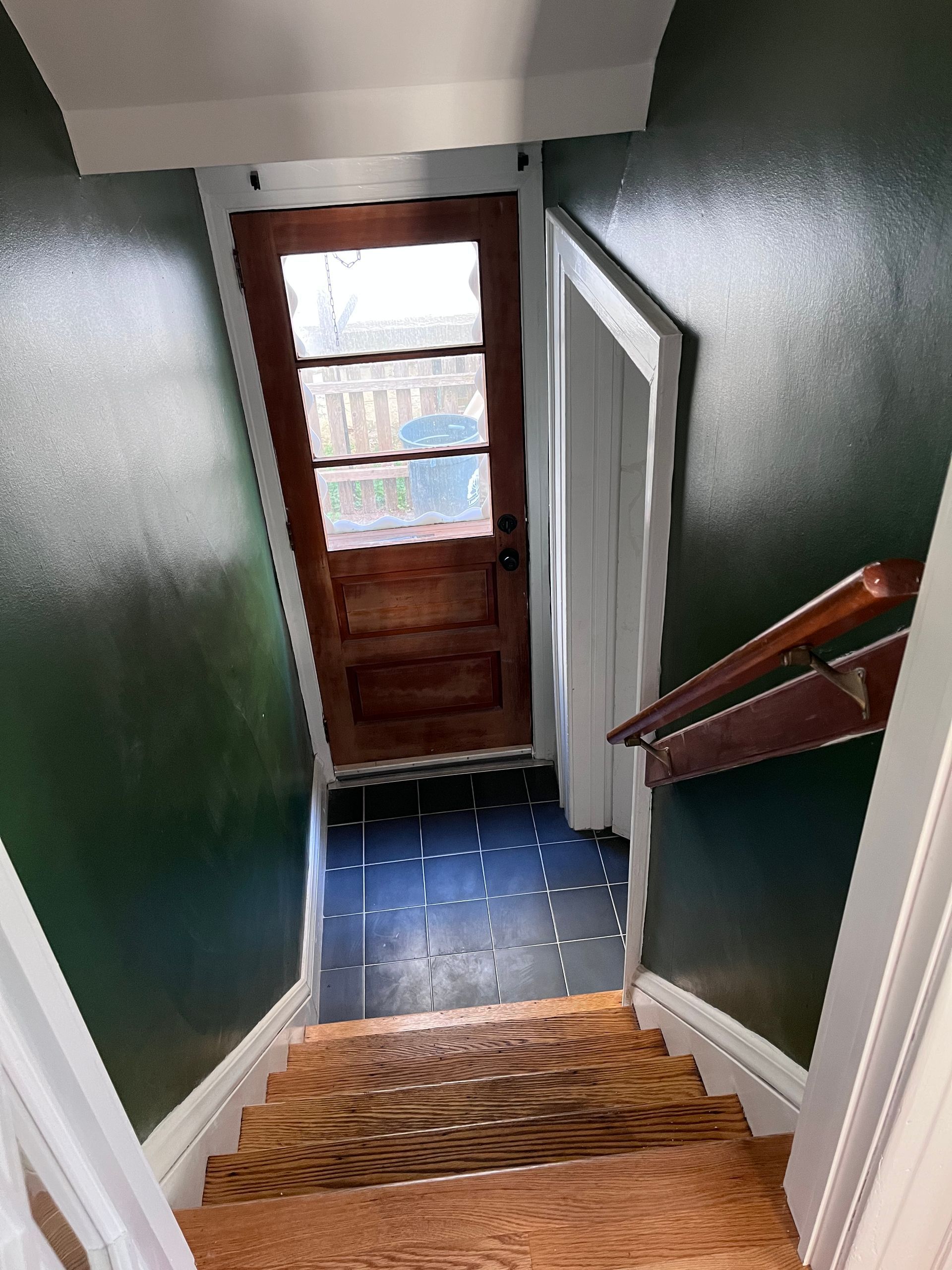 A staircase leading up to a door in a house