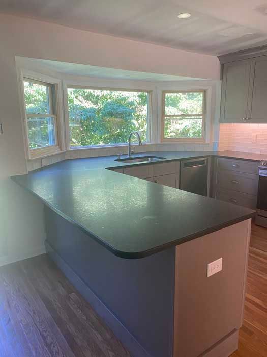A kitchen with a large island and a sink.
