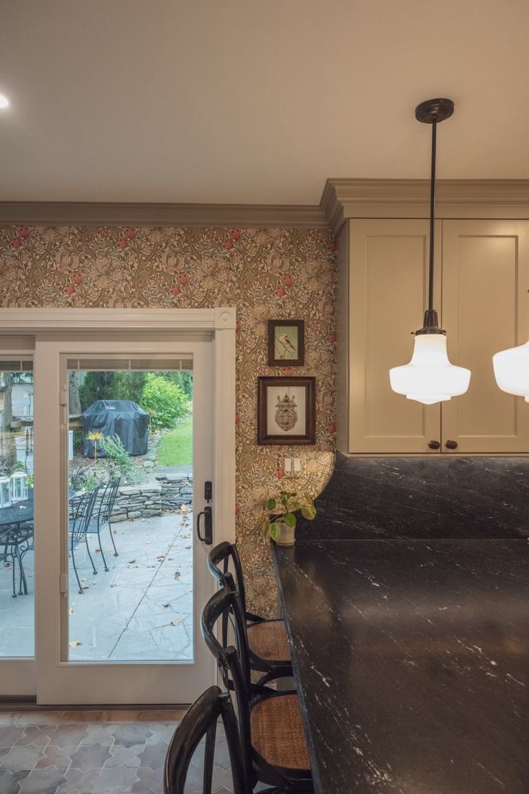 A kitchen with a sliding glass door leading to a patio.