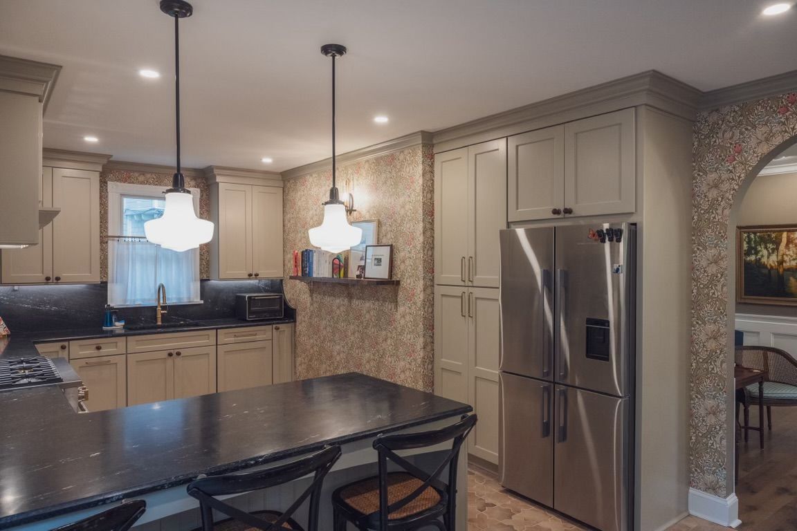 A kitchen with stainless steel appliances and a large island.