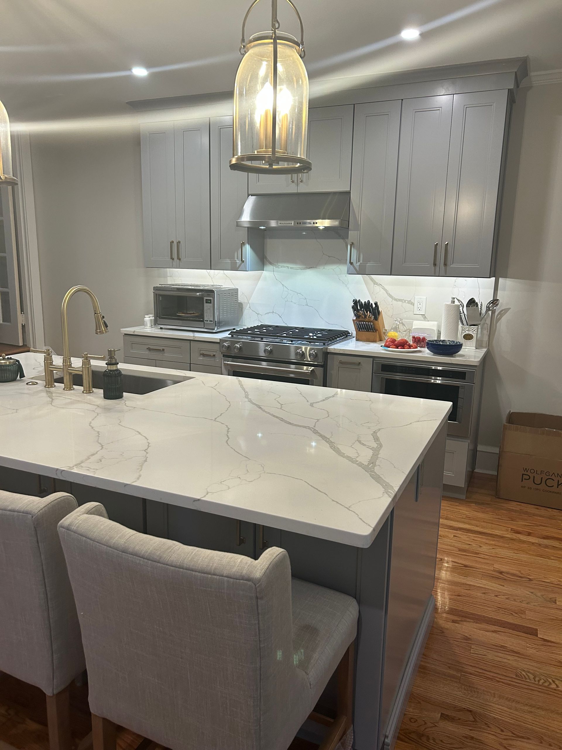 A kitchen with a large island and a stove top oven