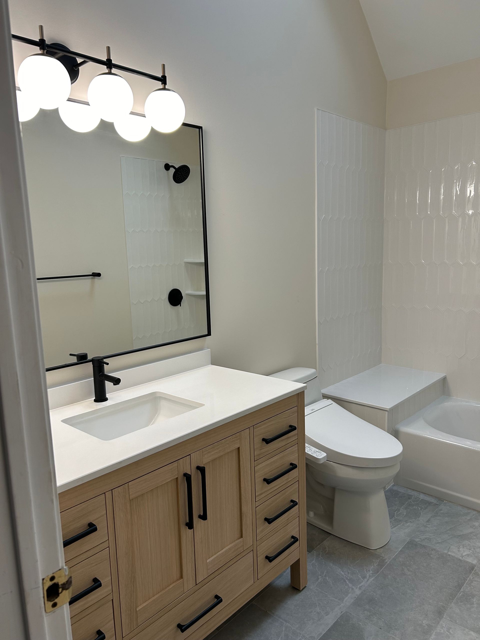 A bathroom with a sink , toilet , and mirror.