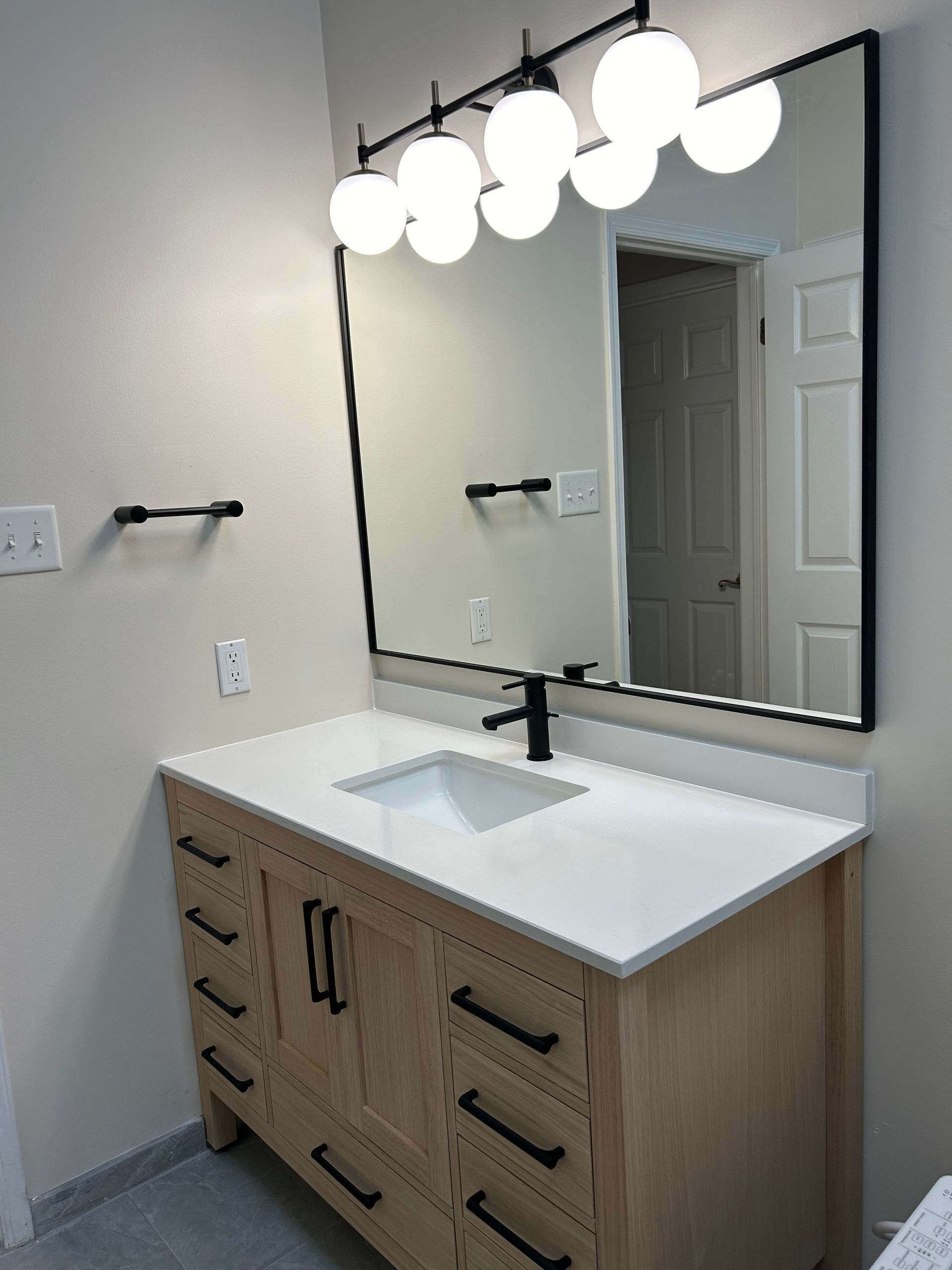 A bathroom vanity with a sink and a mirror.