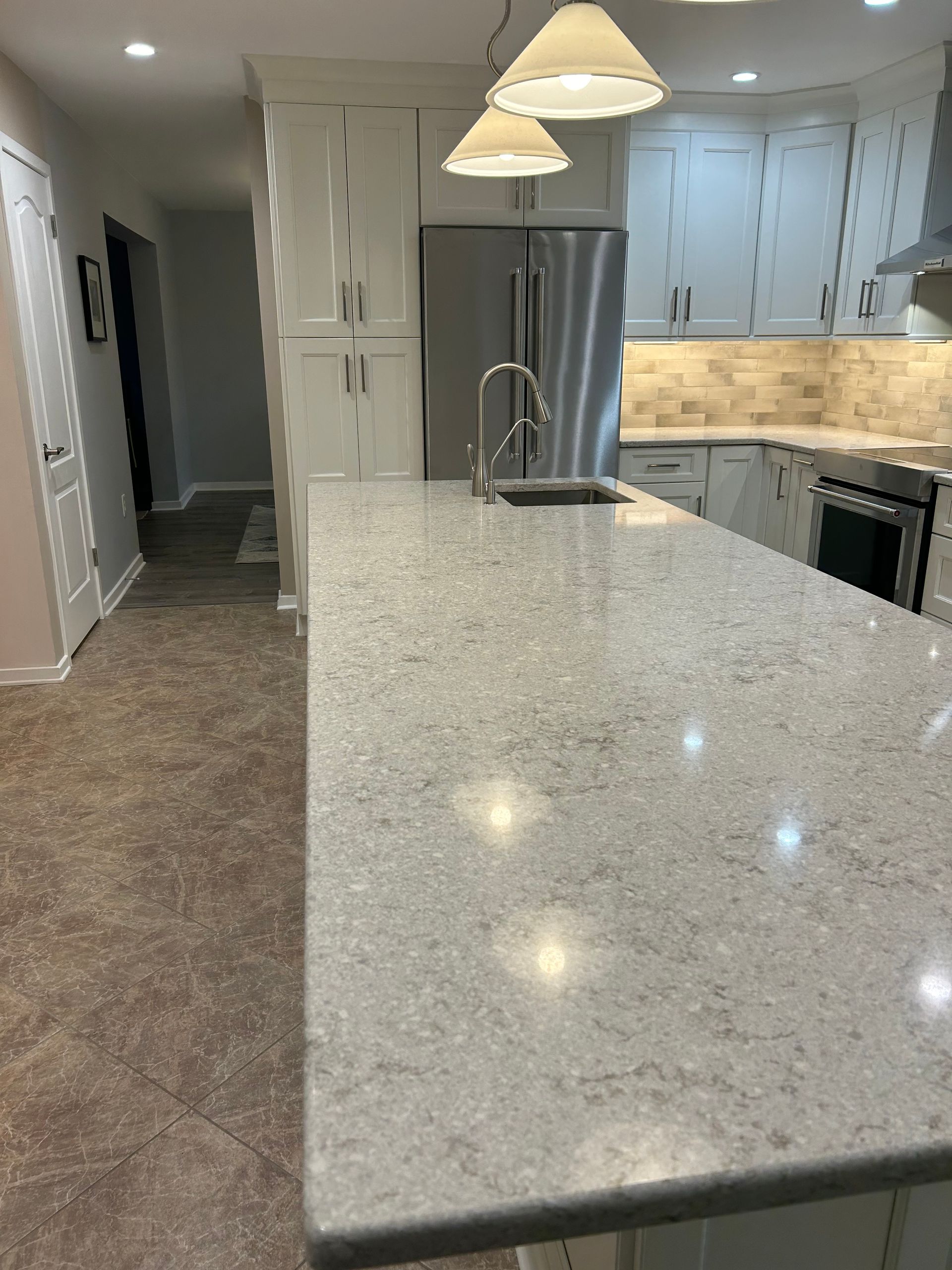 A kitchen with granite counter tops and stainless steel appliances
