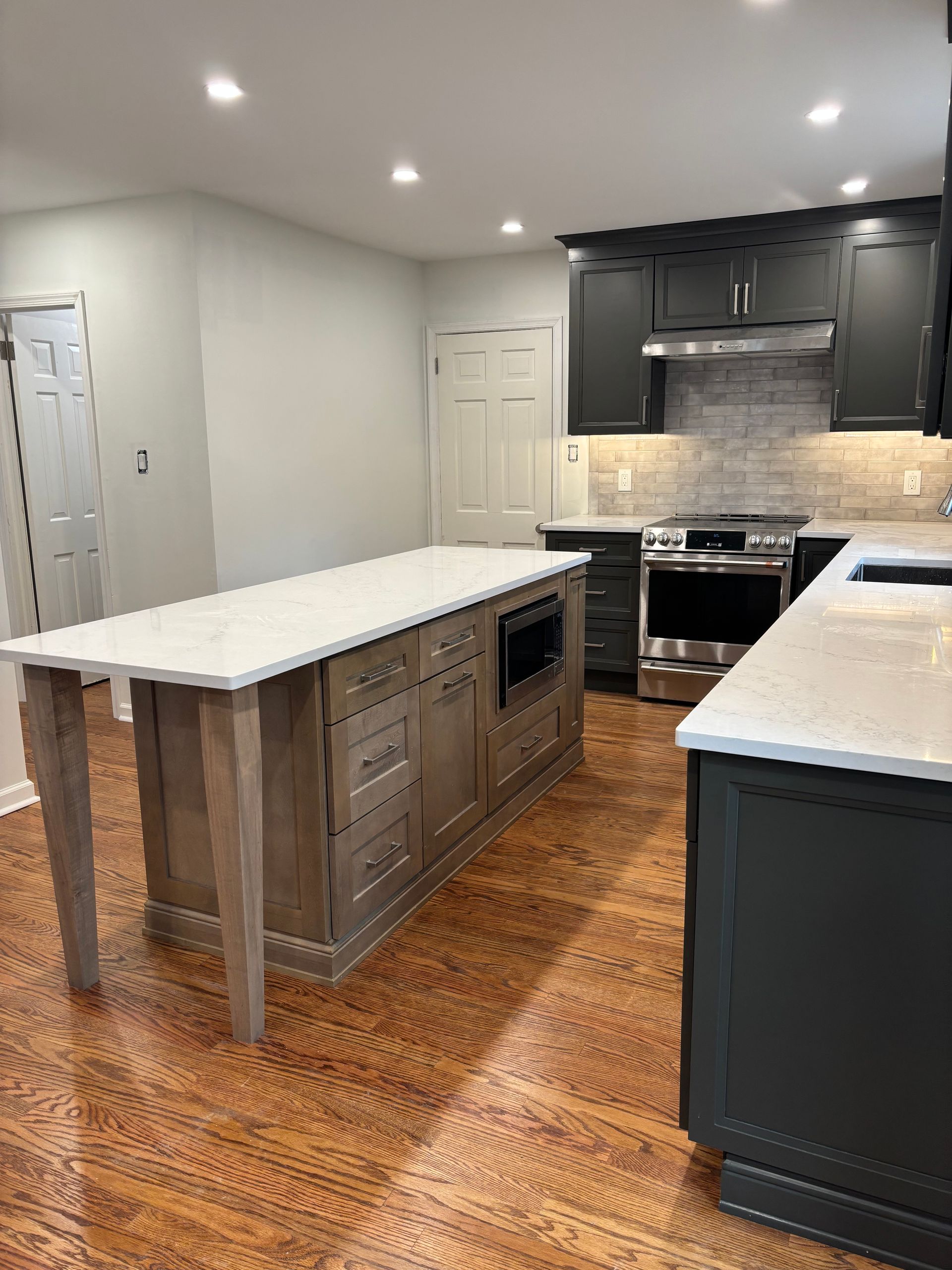 There is a large island in the middle of the kitchen.