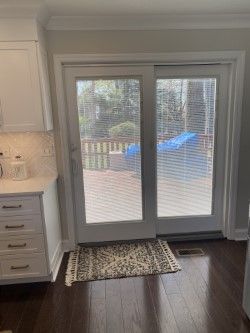 A kitchen with sliding glass doors leading to a deck.