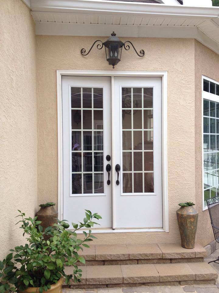 The front door of a house has a lamp above it