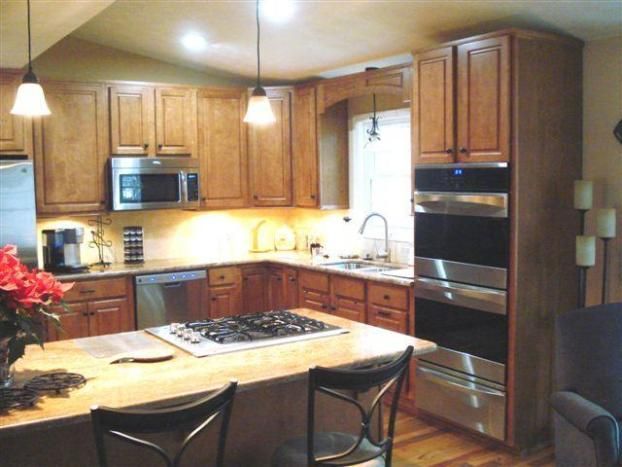 A kitchen with stainless steel appliances and wooden cabinets