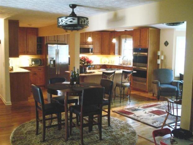 A kitchen with a table and chairs and a ceiling fan