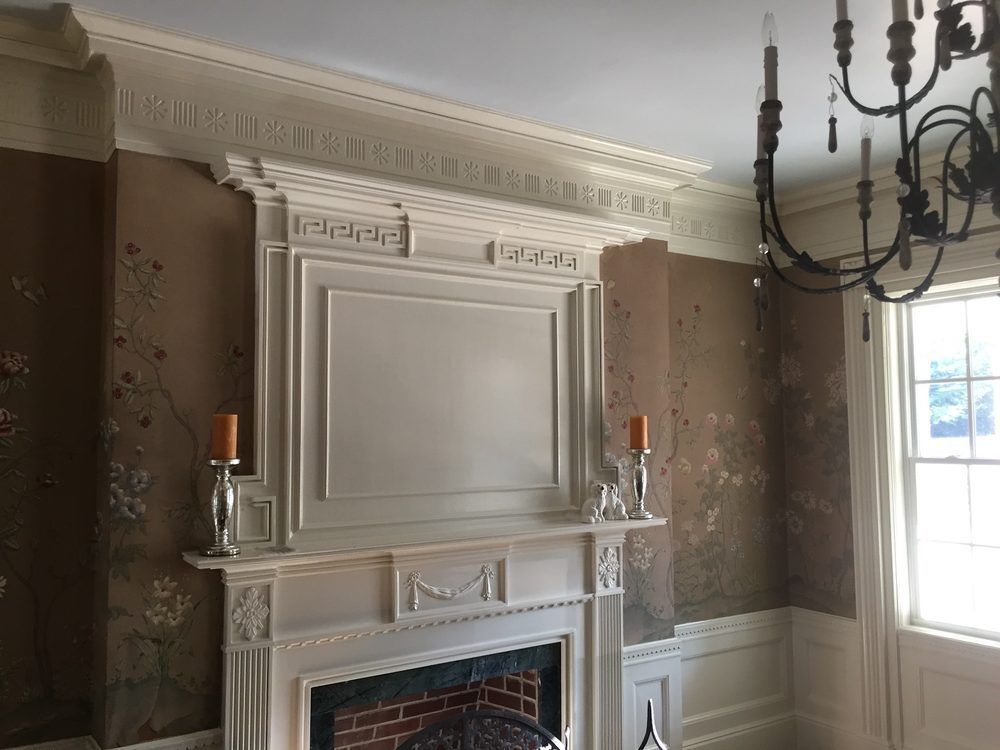 A living room with a fireplace and a chandelier.