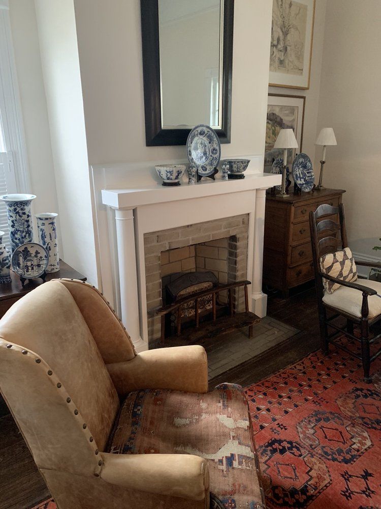 A living room with a fireplace and a chair