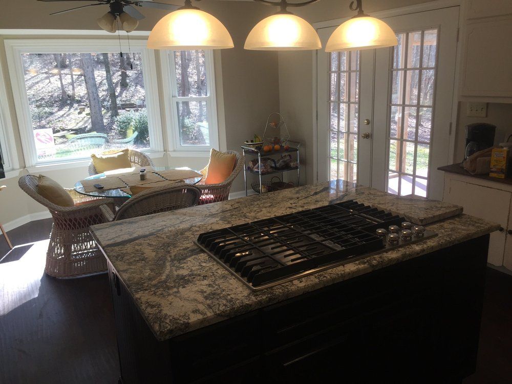 A kitchen with a large island and a stove top oven