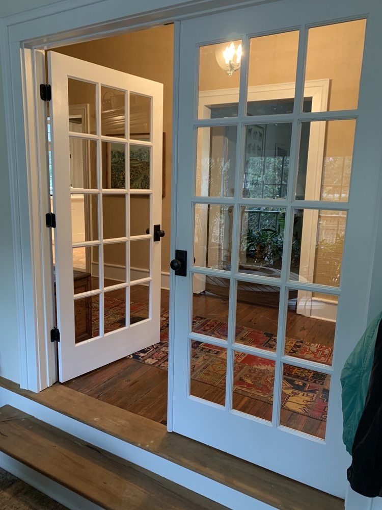 A pair of french doors open to a living room