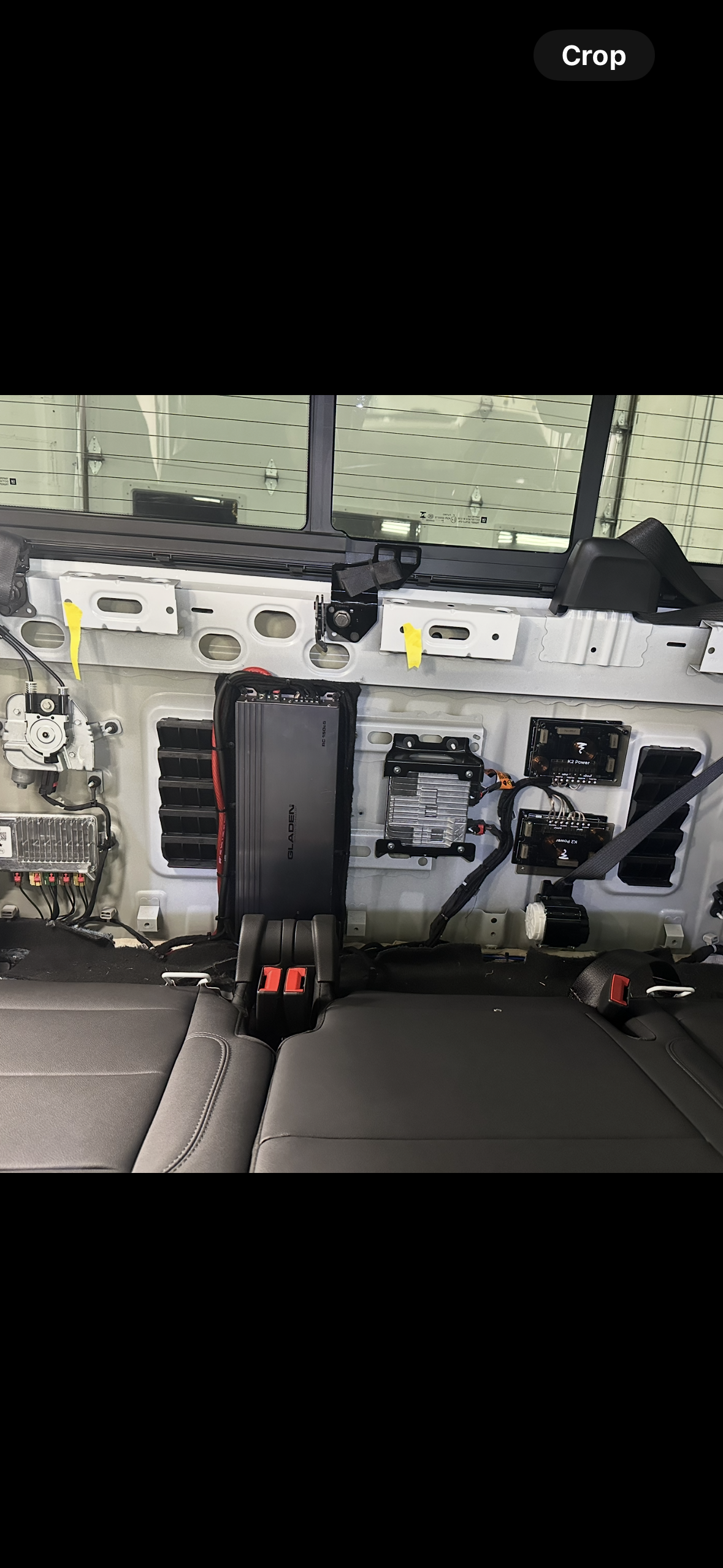 Interior view, airplane cabin with exposed components, seat belts, and air vents.