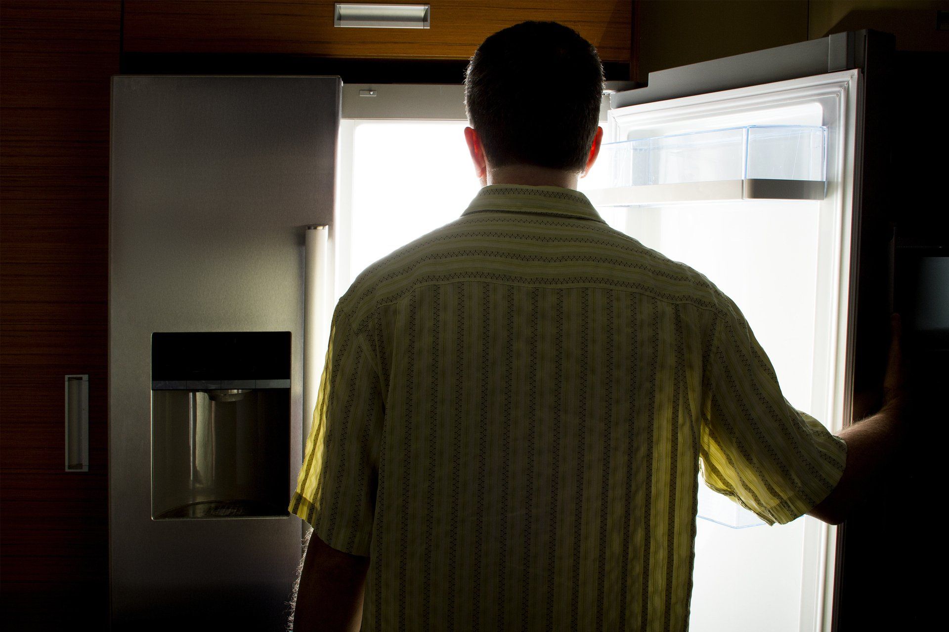 Man Looking For Food In An Open Refrigerator — Robertson, TN — Jeff Delong Repair Service