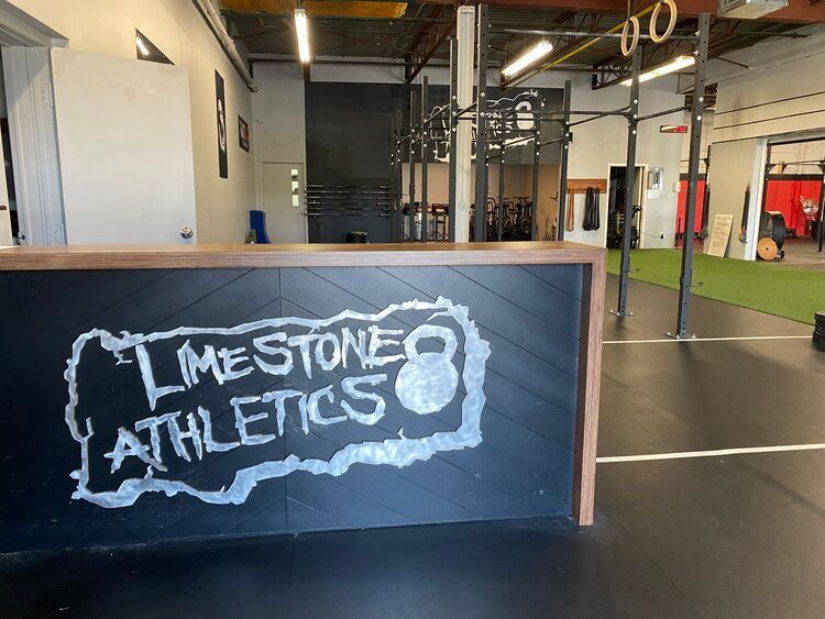 A gym with a sign that says limestone athletics on it