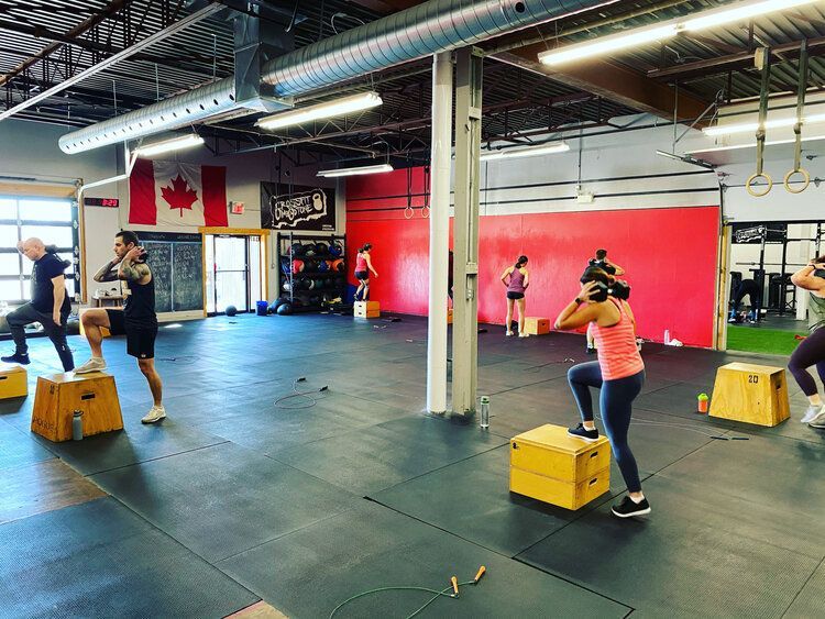 A group of people are doing exercises in a gym.