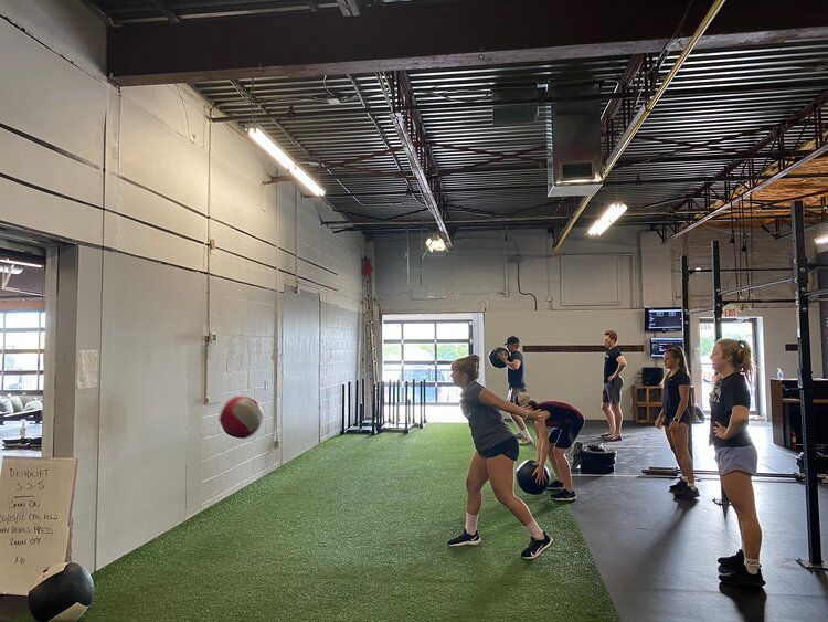 A group of people are doing exercises in a gym.
