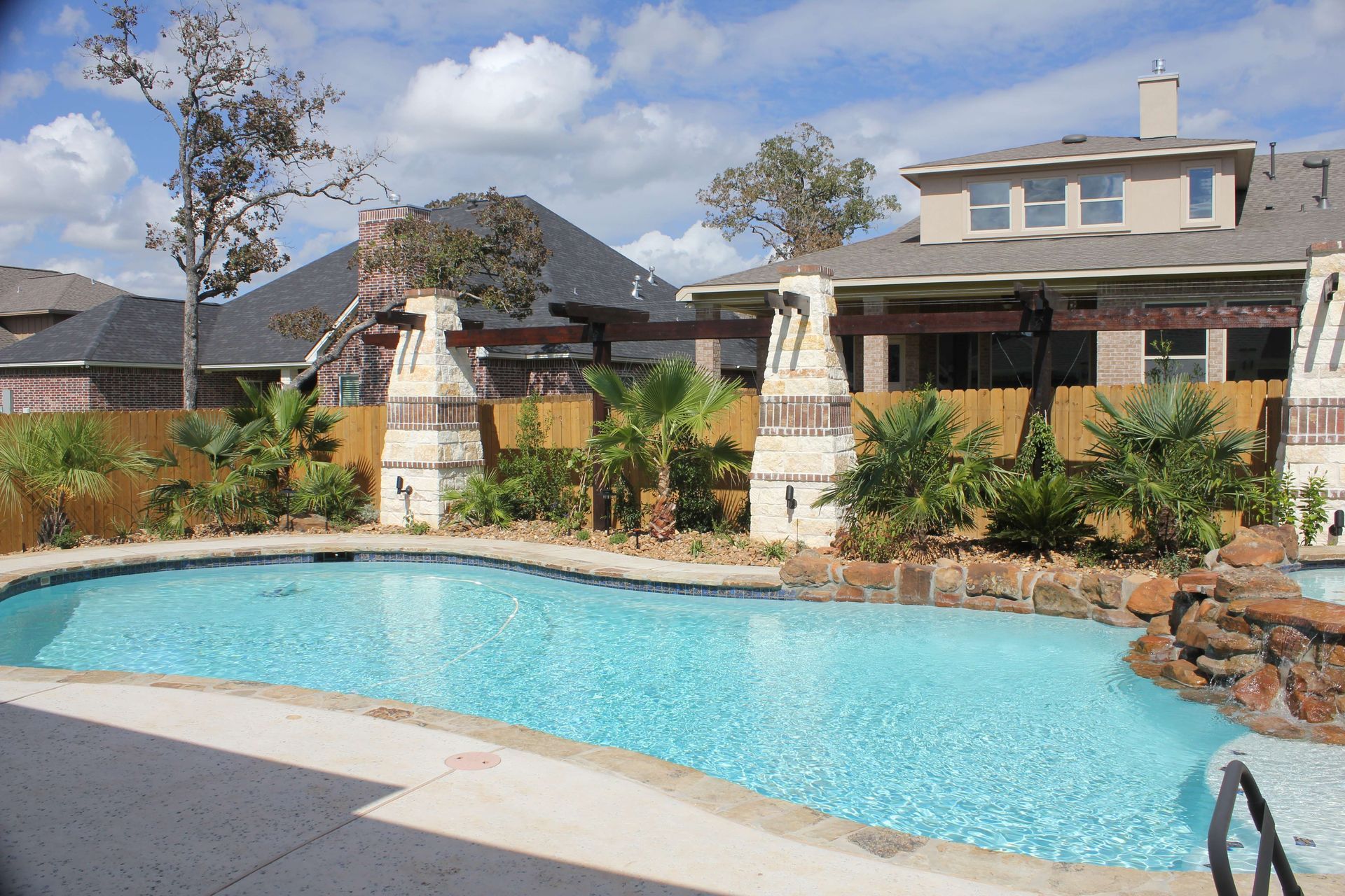 A large swimming pool in front of a house
