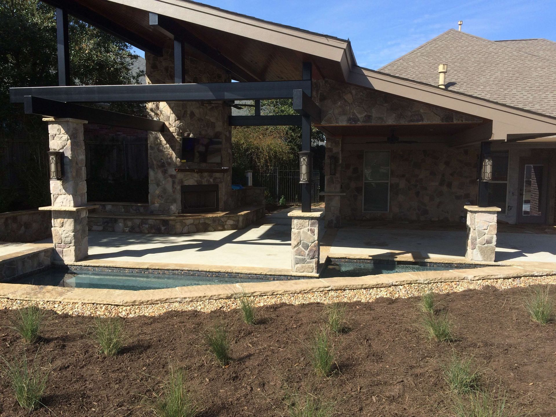 A house with a patio and a pool in front of it