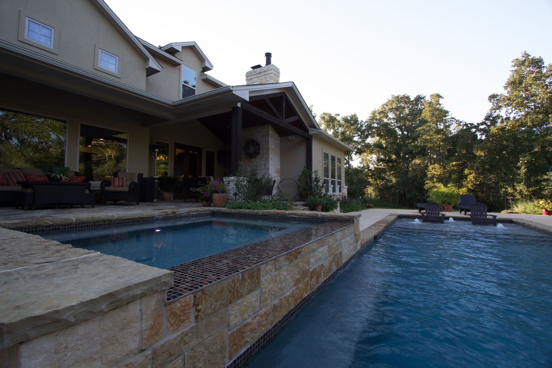 A large house with a large swimming pool in front of it