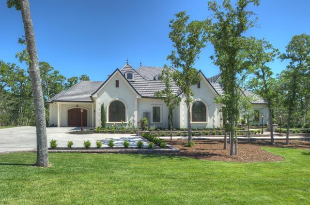 A large white house with a lot of trees in front of it