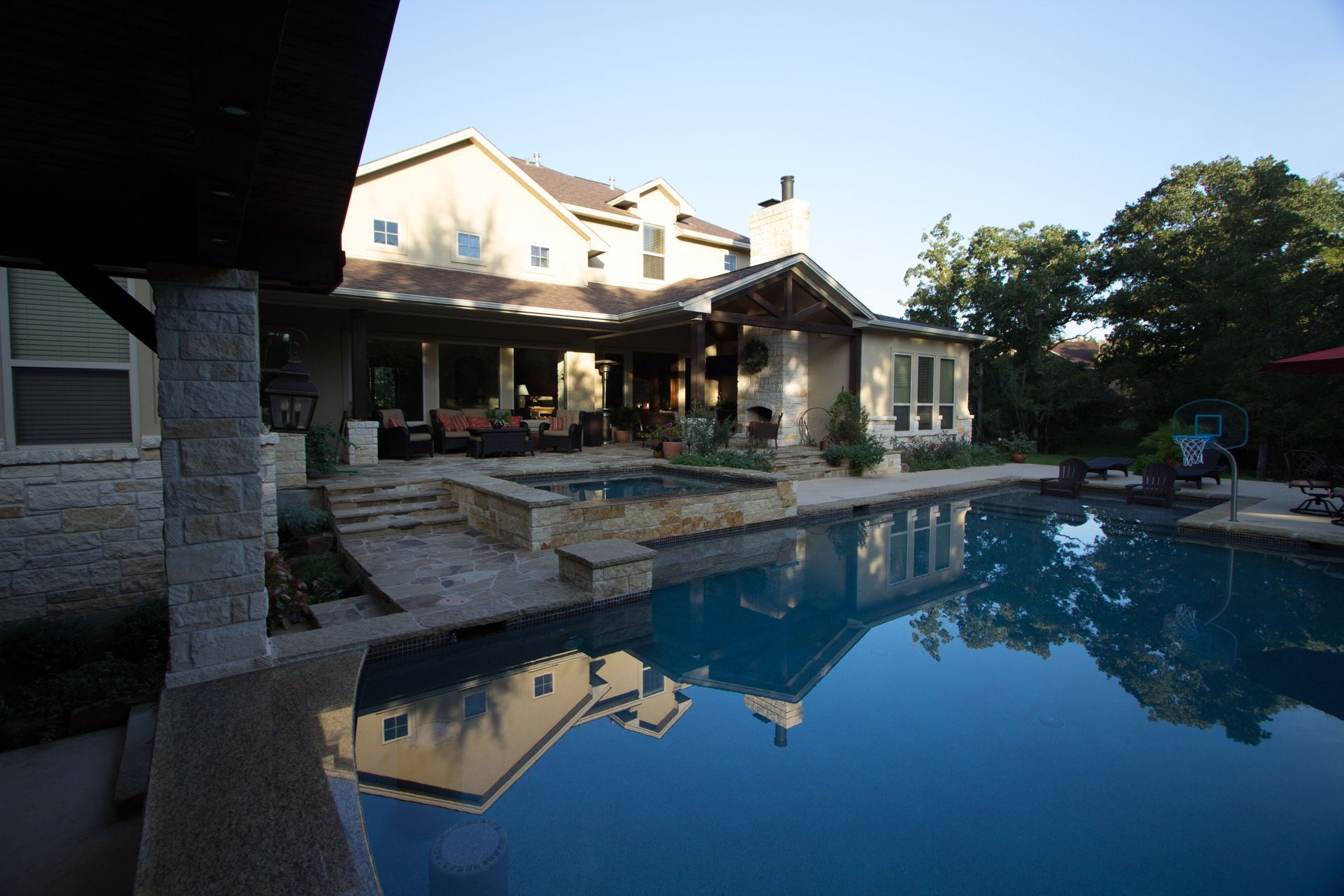 A large house with a large swimming pool in front of it