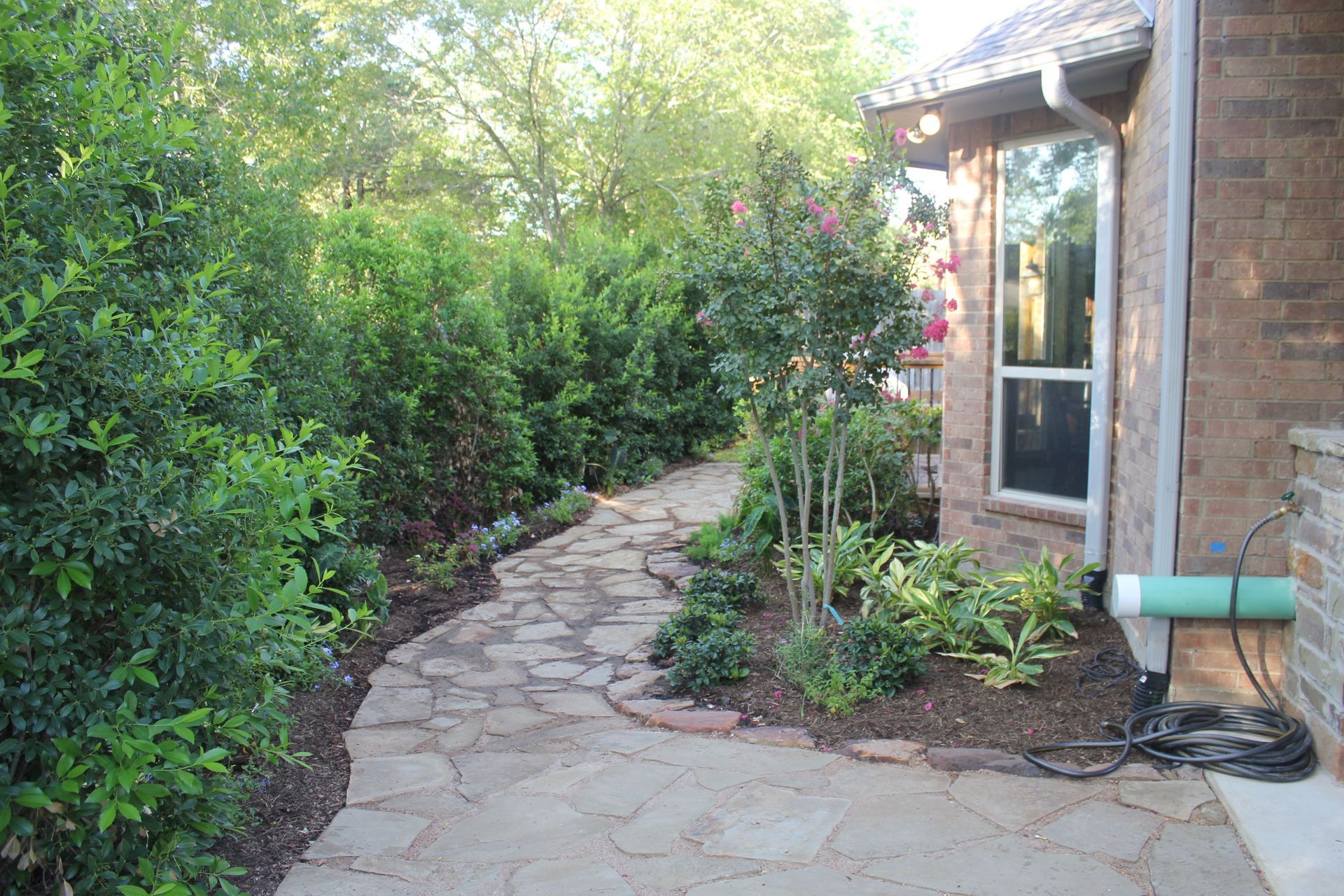 A brick house with a stone walkway leading to it