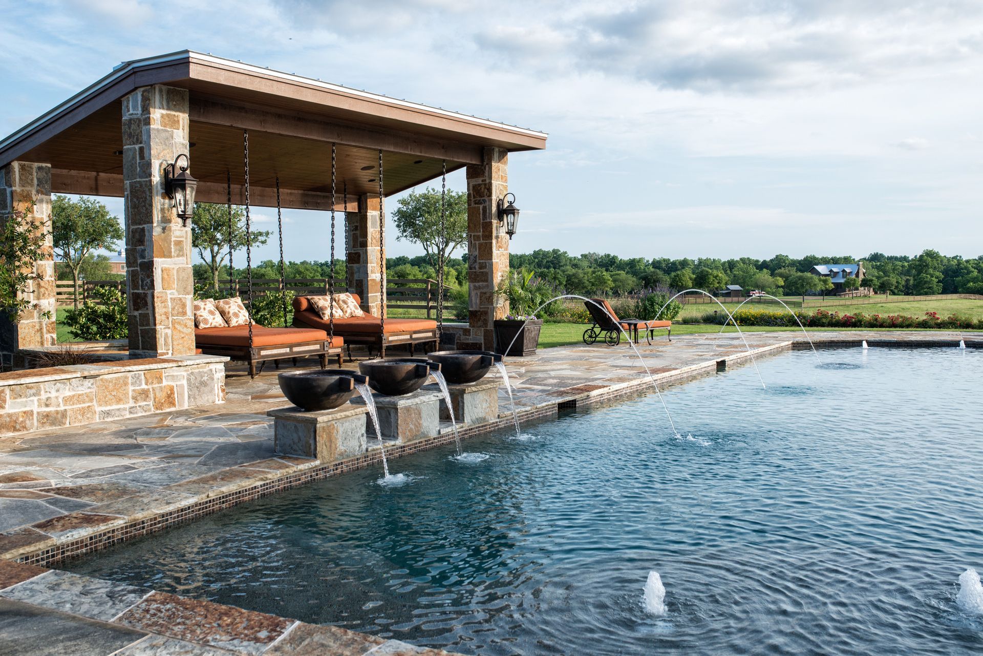 There is a large swimming pool with a gazebo in the background.