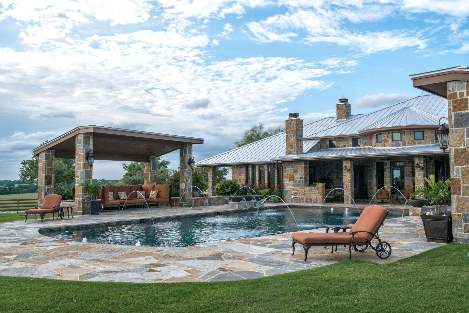 A large house with a large swimming pool in front of it.