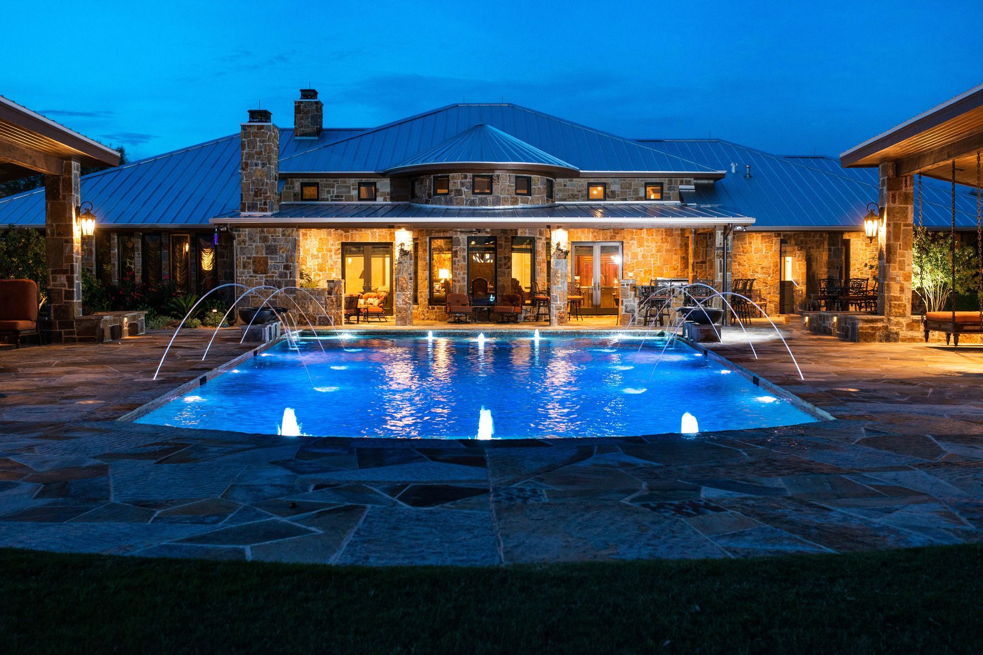 A large house with a large swimming pool in front of it