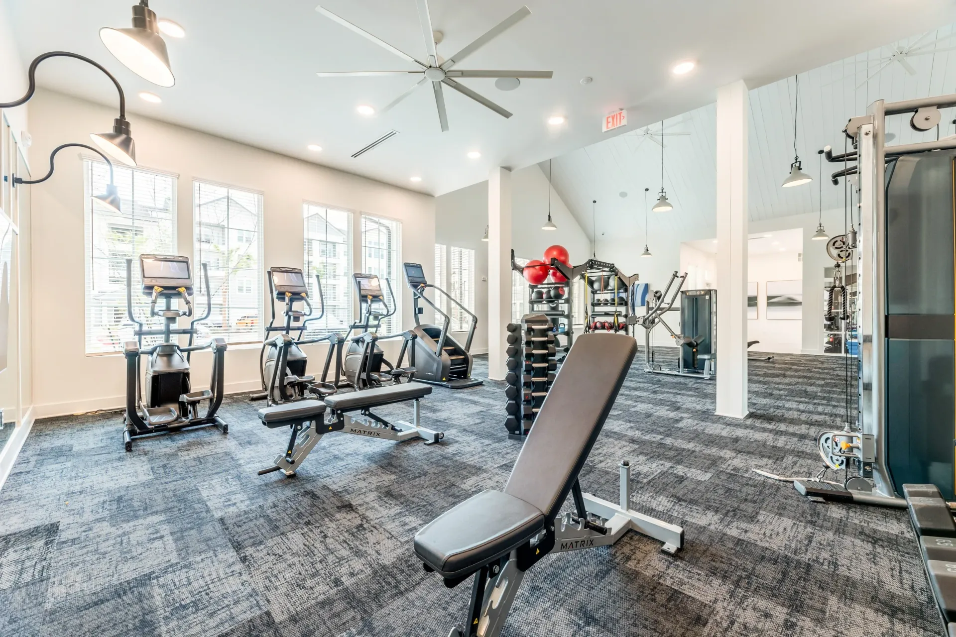 Fitness center with cardio machines, weight benches, and weight racks.