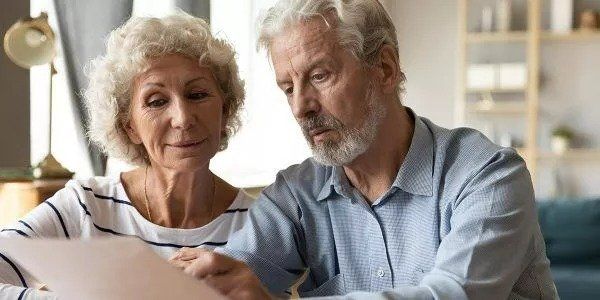 Senior Couple Reading Paper — Deerfield Beach, FL — Blade & Blade P.A.