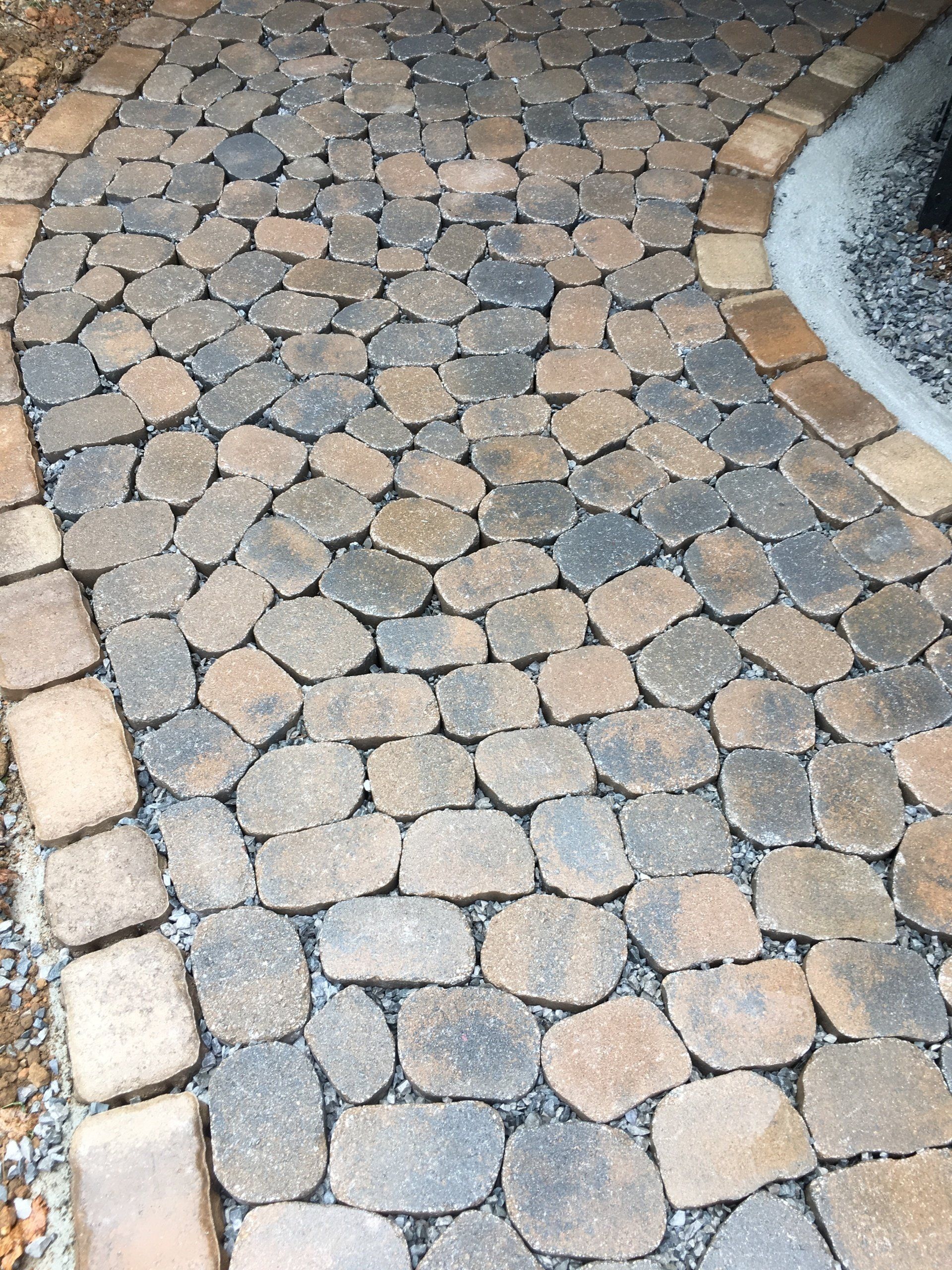 A walkway made of bricks with a circle in the middle
