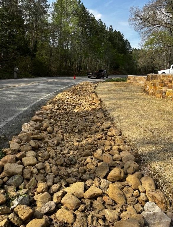 A pile of rocks along the side of a road.