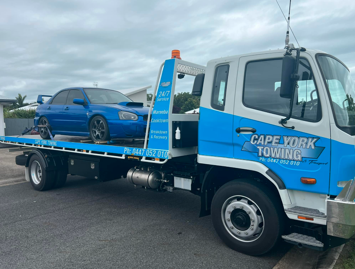 Tow Truck Lifting A Red Car