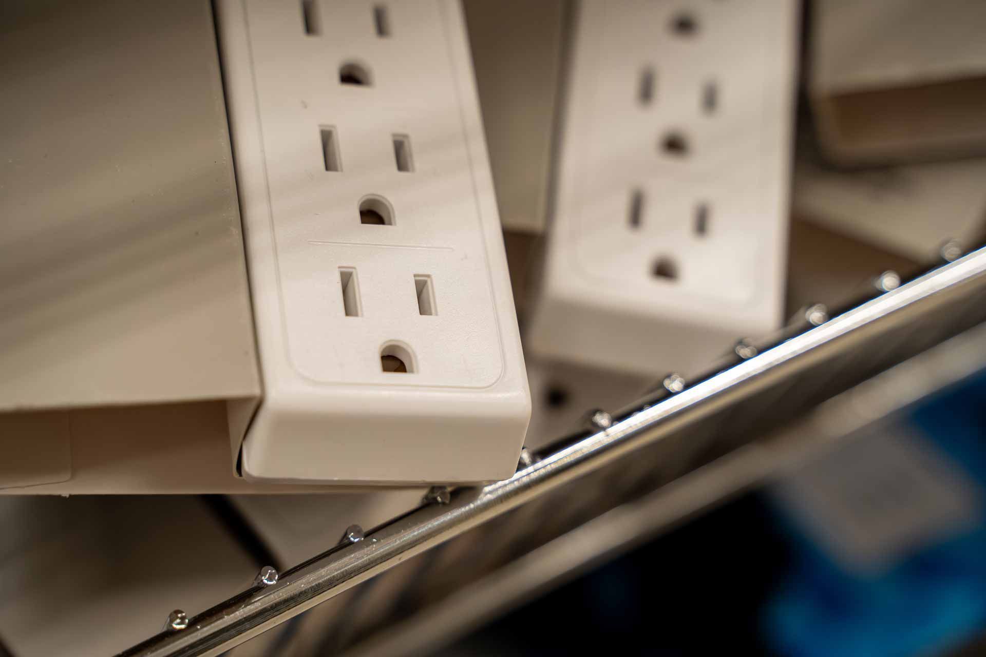 White power strips on a metal surface, with a blurred blue object in the foreground.