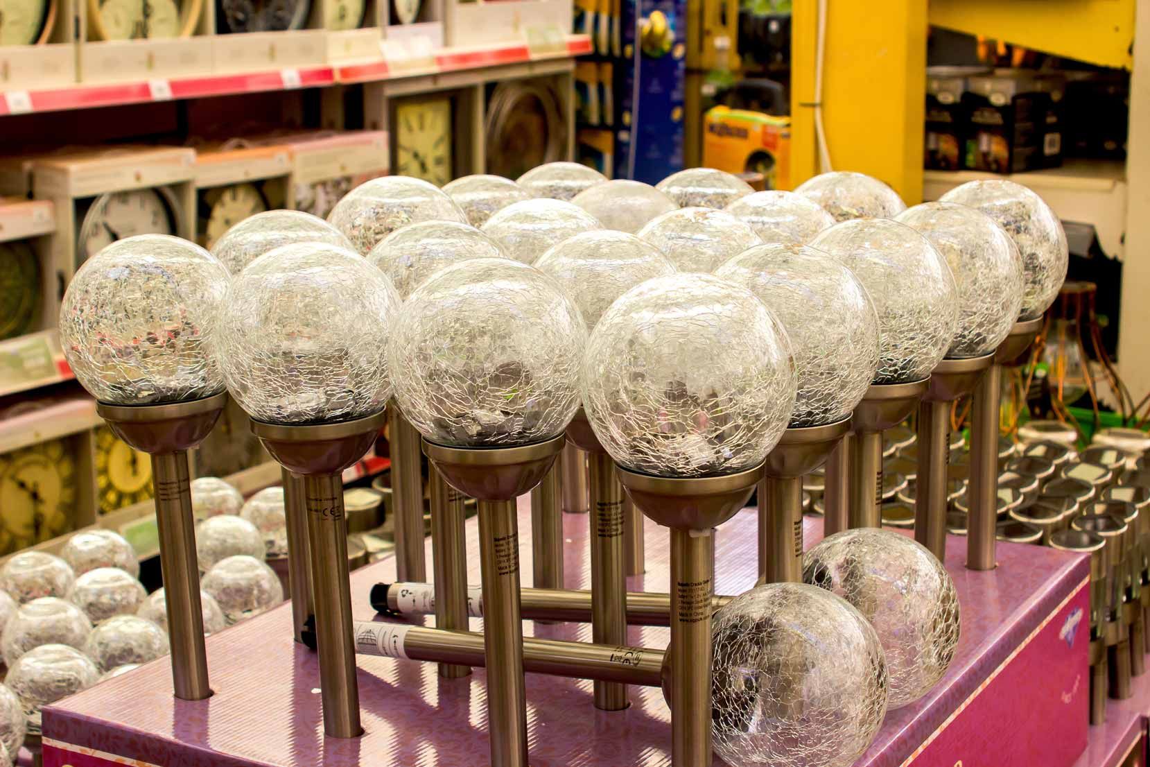 Metal spheres on stands in a workshop, with white textured tops and pink base plate