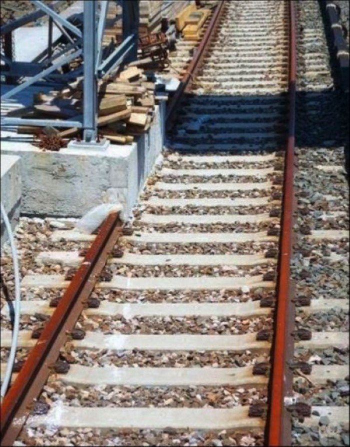 a close up of a train track with a shadow on it